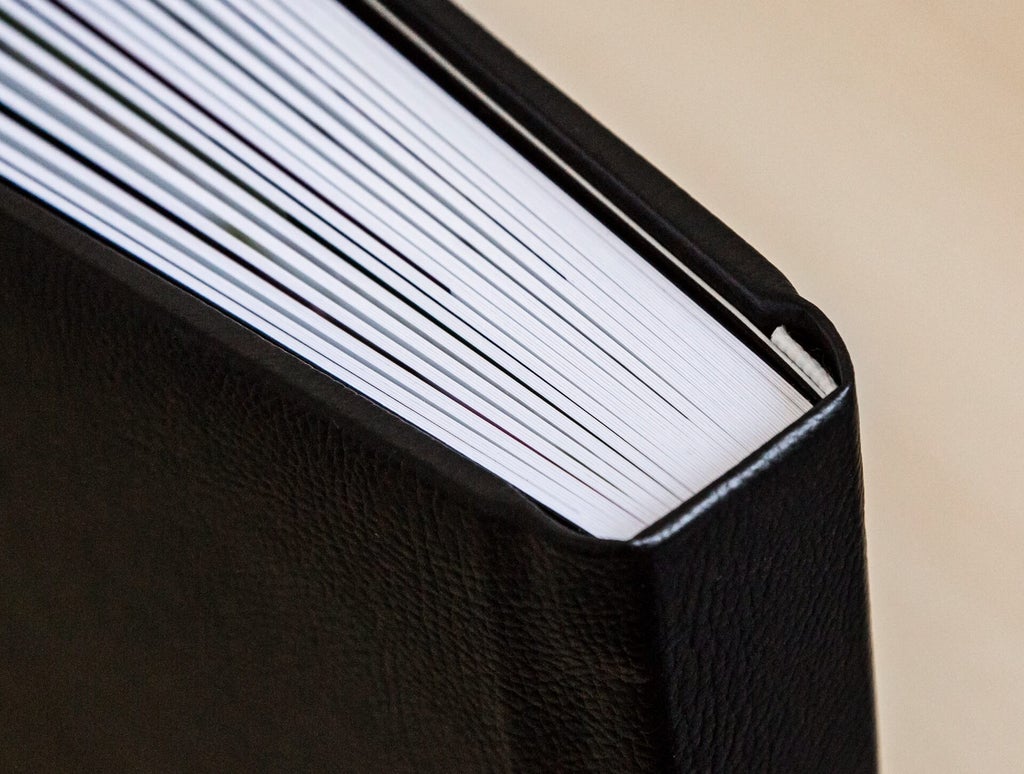 A close up look at the thick pages of a family photo album.